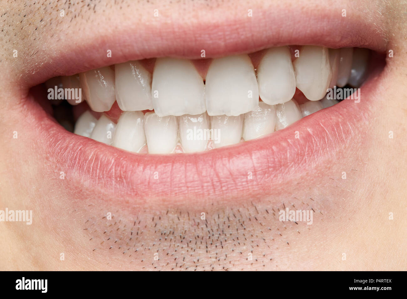 Close-up of mans smile with clean white teeth Stock Photo