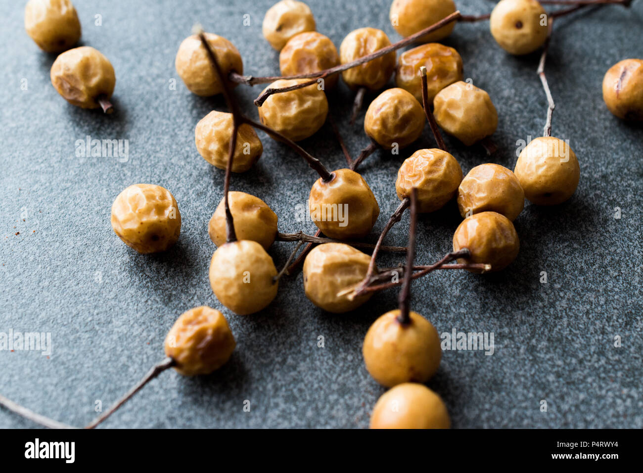 Dried Immature Unripe Dry Yellow Dates from Palm Tree with Stalks