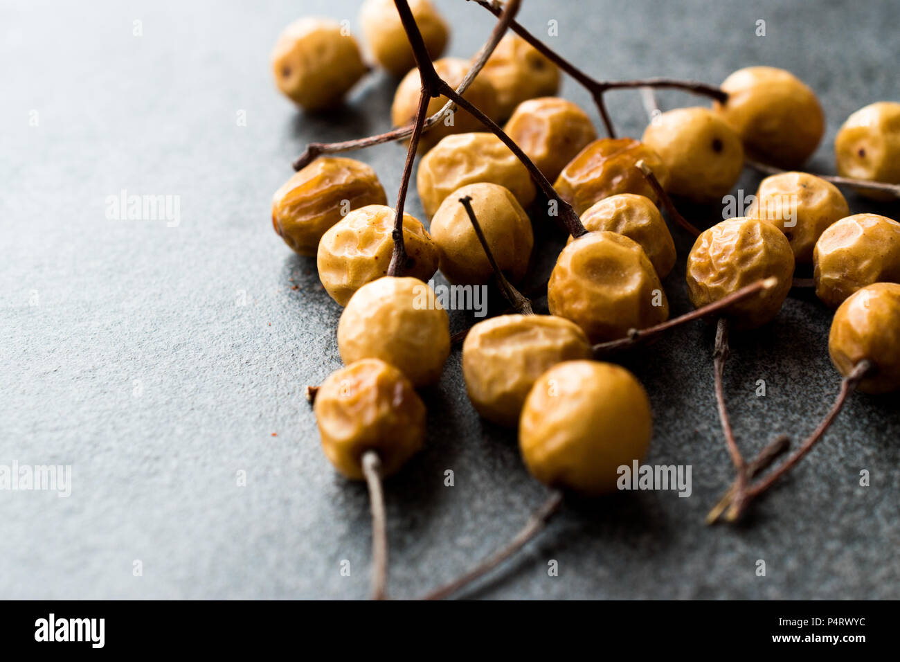 Dried Immature Unripe Dry Yellow Dates from Palm Tree with Stalks
