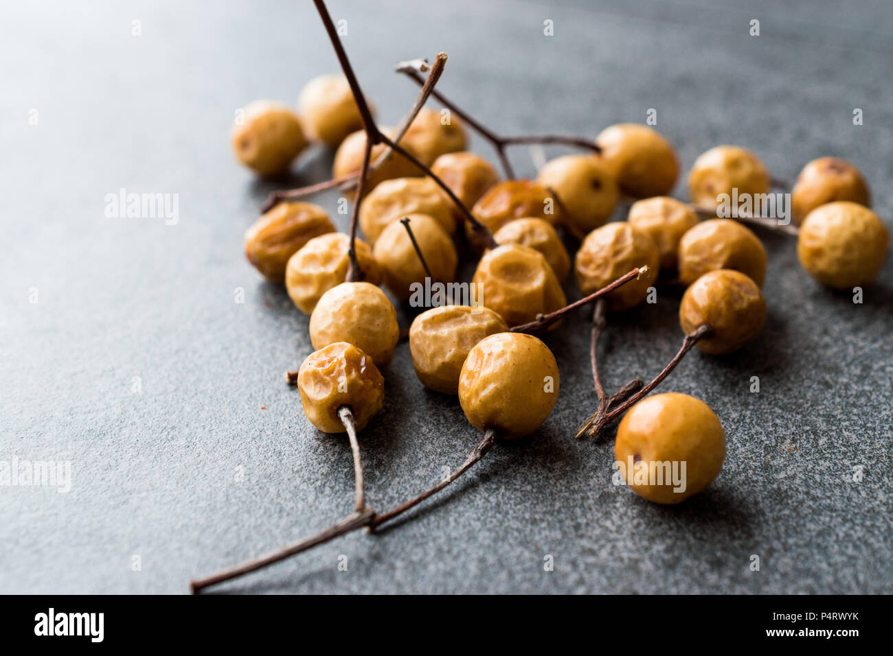 Dried Immature Unripe Dry Yellow Dates from Palm Tree with Stalks