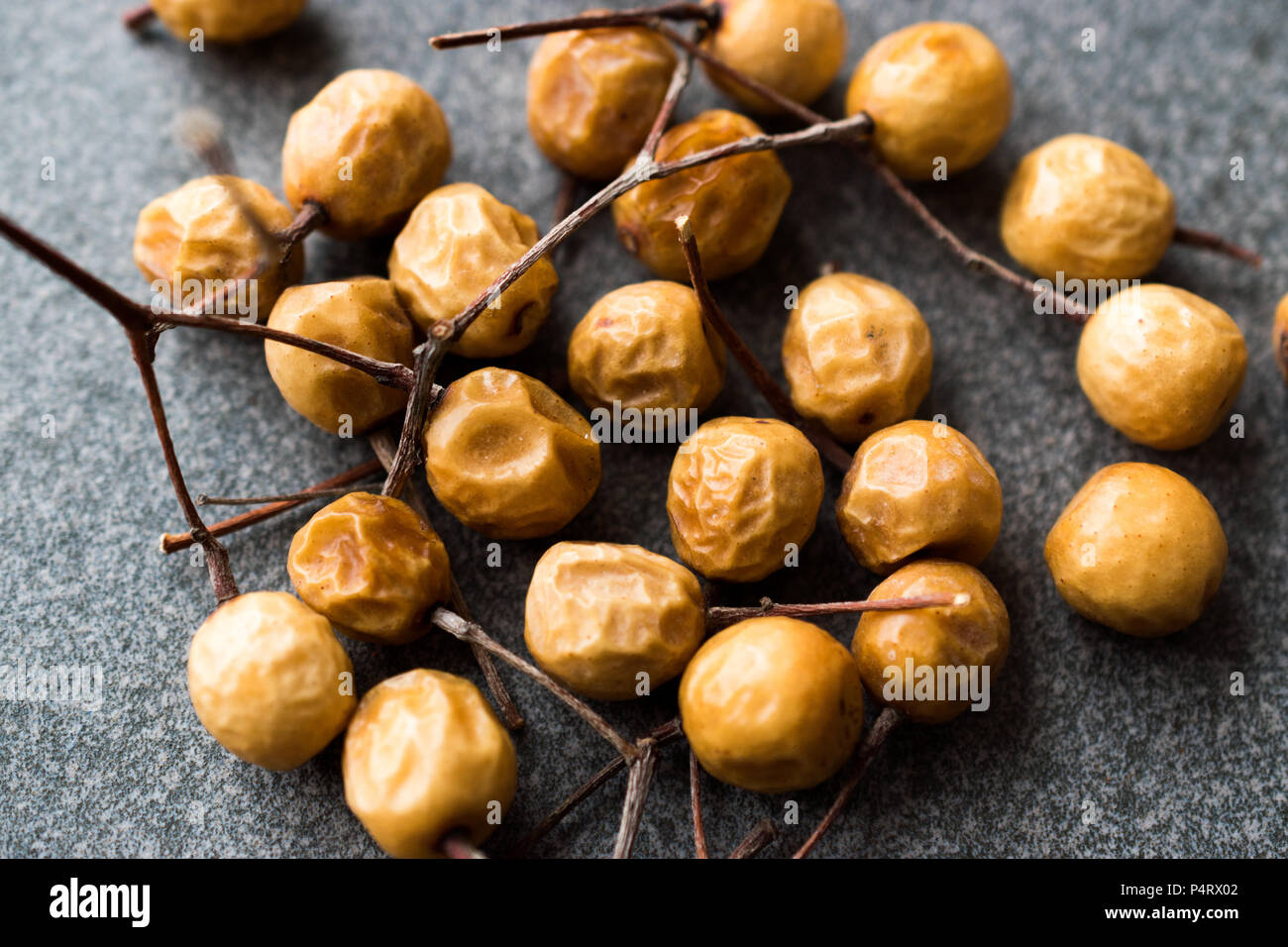 Dried Immature Unripe Dry Yellow Dates from Palm Tree with Stalks