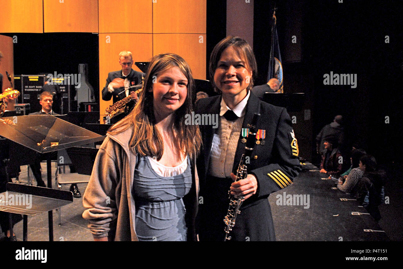 ANN ARBOR, MI.  (March 10, 2012) Chief Musician Laura Grantier, assistant principal clarinetist of the U.S. Navy Band, talks with Lizzy Lee, a clarinet student at Slauson Middle School after the Band's tour performance at the Schreiber Auditorium in Ann Arbor, Mich.  This was the Band's fifth day of their 26 day National Spring Tour of the Midwest. Stock Photo