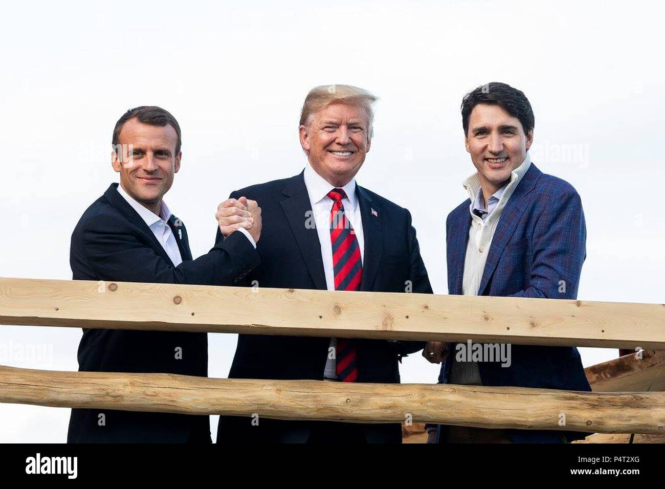 U.S. President Donald Trump, center, with Canadian Prime Minister Justin Trudeau, right, and French President Emmanuel Macron, at the working dinner during the G7 Summit at the Black Bear Chalet June 8, 2018 in La Malbaie, Quebec. Stock Photo