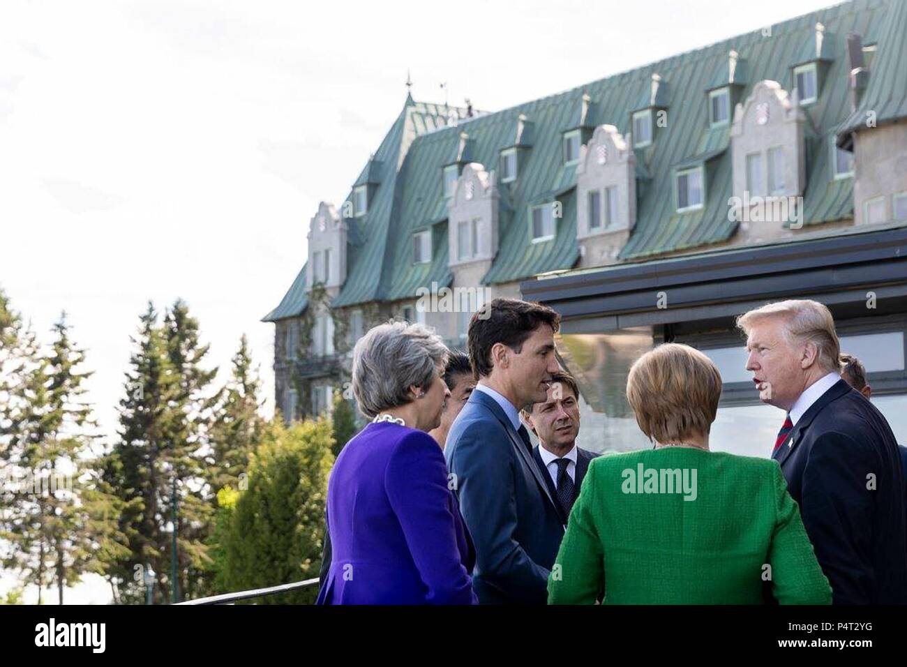 U.S. President Donald Trump, right, chats with Canadian Prime Minister Justin Trudeau, Italian Prime Minister Giuseppe Conte, German Chancellor Angela Merkel and British Prime Minister Theresa May, right during a working lunch at the G7 Summit June 8, 2018 in Charlevoix, Quebec, Canada. Stock Photo