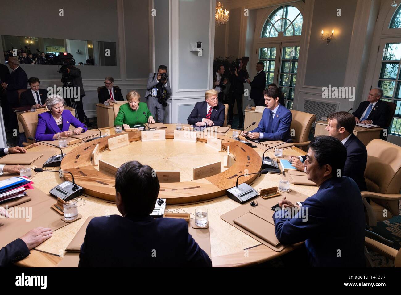 U.S. President Donald Trump and world leaders attends a working session of the Charlevoix G7 Summit June 8, 2018 in Charlevoix, Quebec, Canada. Sitting from left to right are:  British Prime Minister Theresa May, German Chancellor Angela Merkel, President Donald Trump, Canadian Prime Minister Justin Trudeau, French President Emmanuel Macron, Japanese Prime Minister Shinzo Abe and Italian Prime Minister Giuseppe Conte. Stock Photo