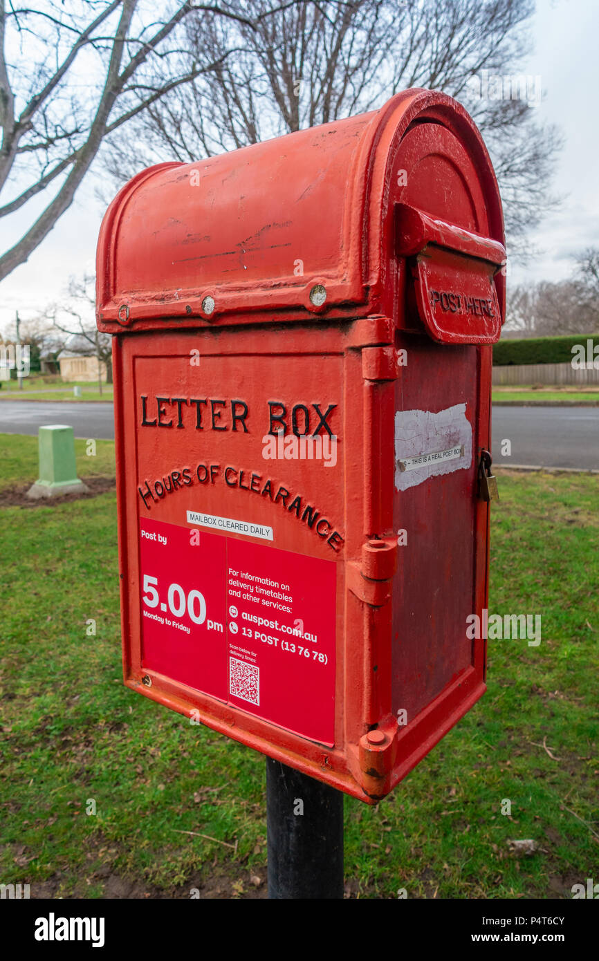 Red Letter Box at front of Post Office.  A small note on side says  'This is a real post box' . Ross Village, Tasmania, Australia. Stock Photo