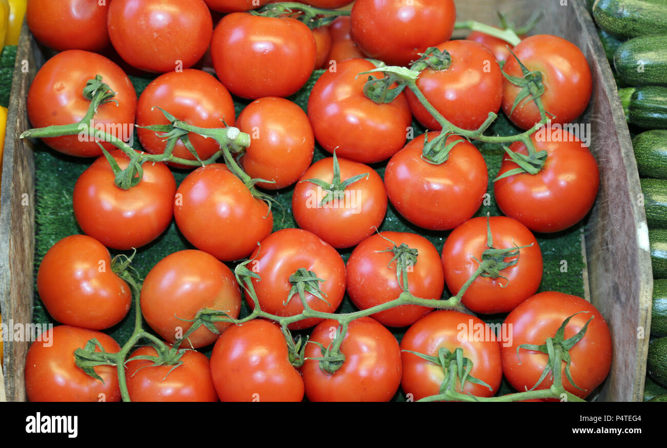 box of big and juicy red tomatoes for sale at a local market stall ...