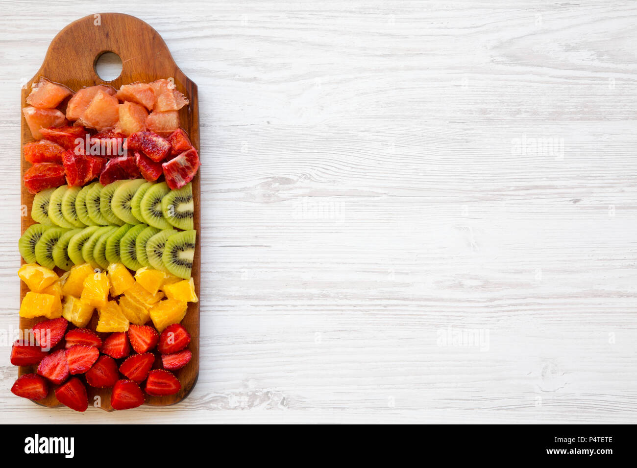 Chopped Fresh Fruits Arranged On Cutting Board On White Wooden Background  With Copy Space, Top View. Ingredients For Fruit Salad. From Above, Flat  Lay, Overhead. Stock Photo, Picture and Royalty Free Image.