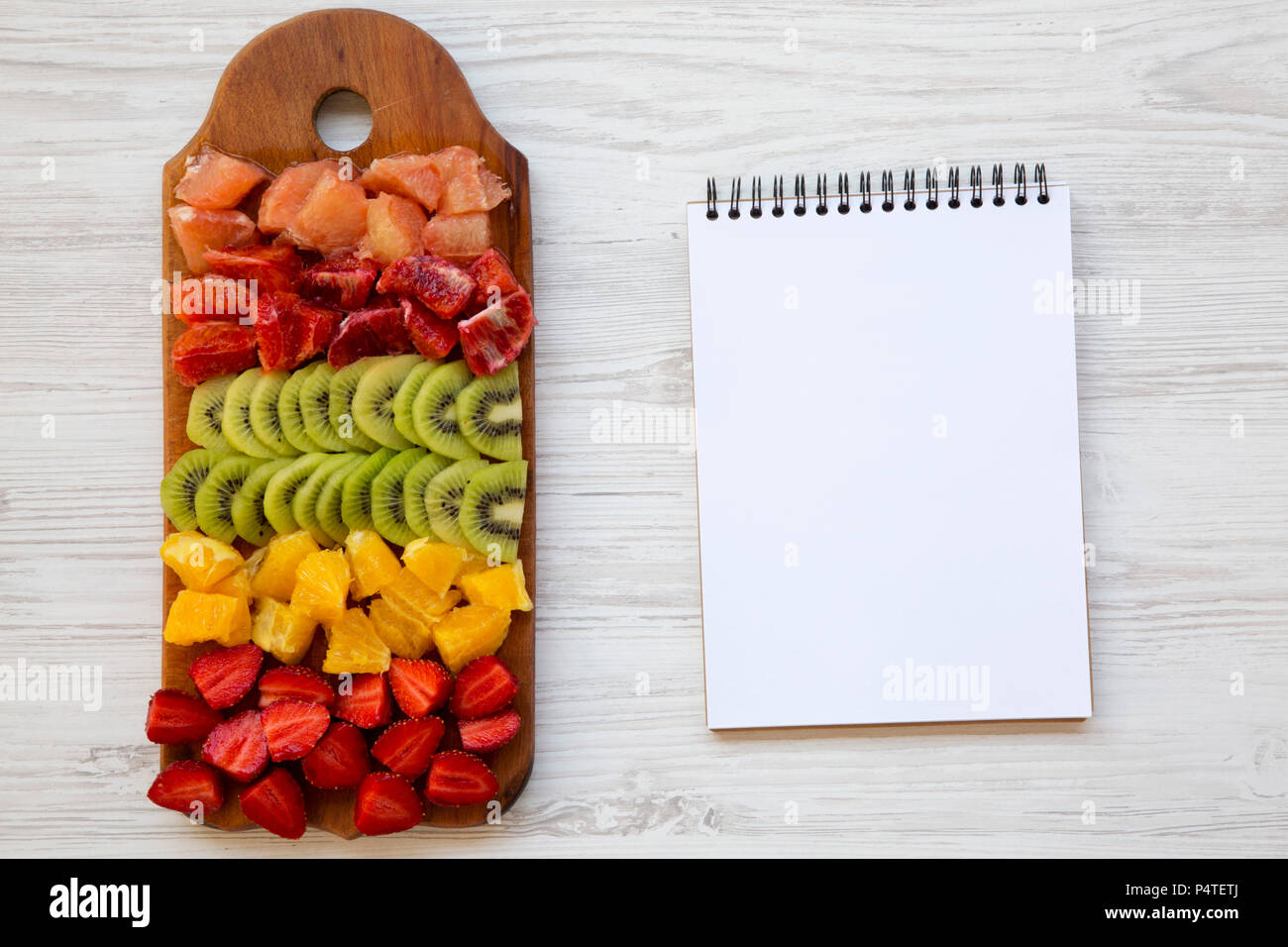 Chopped Fresh Fruits Arranged On Cutting Board On White Wooden Background  With Copy Space, Top View. Ingredients For Fruit Salad. From Above, Flat  Lay, Overhead. Stock Photo, Picture and Royalty Free Image.