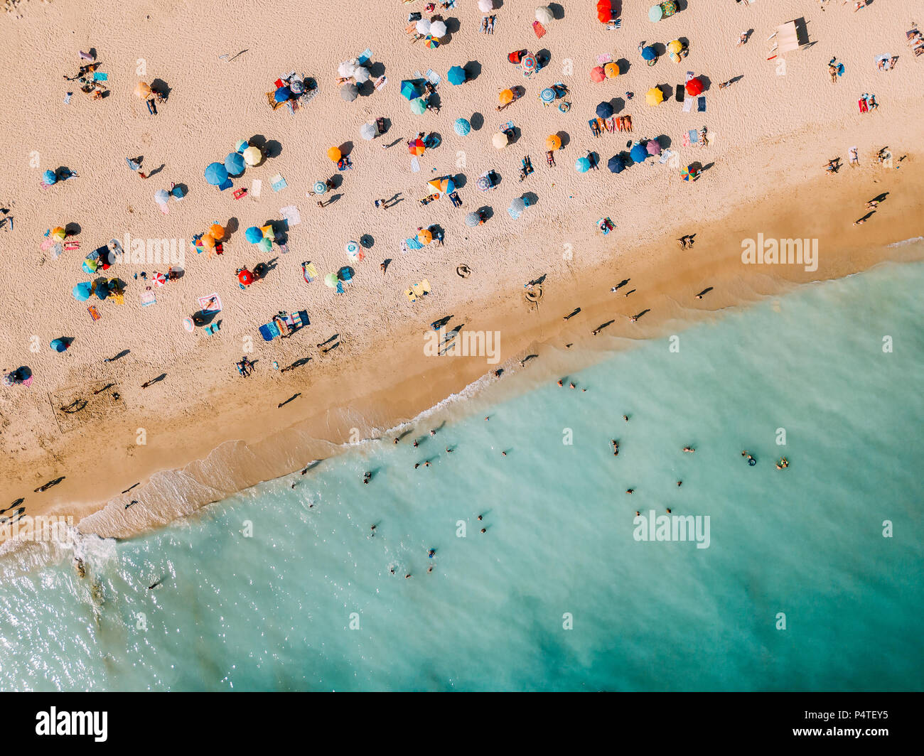 Aerial View From Flying Drone Of People Crowd Relaxing On Algarve Beach In  Portugal Stock Photo - Alamy