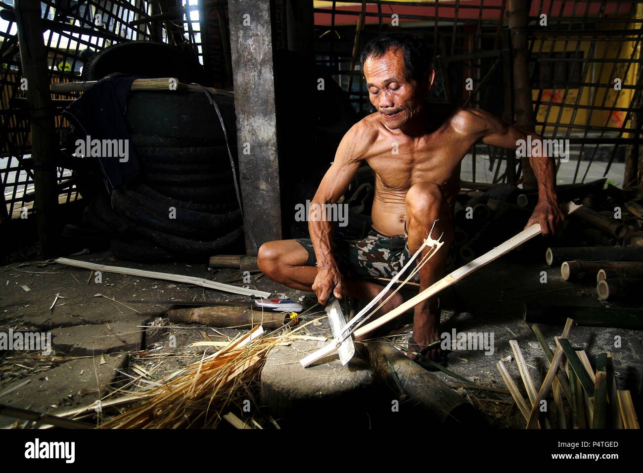 Photo of a bamboo furniture maker cutting bamboo Stock Photo Alamy