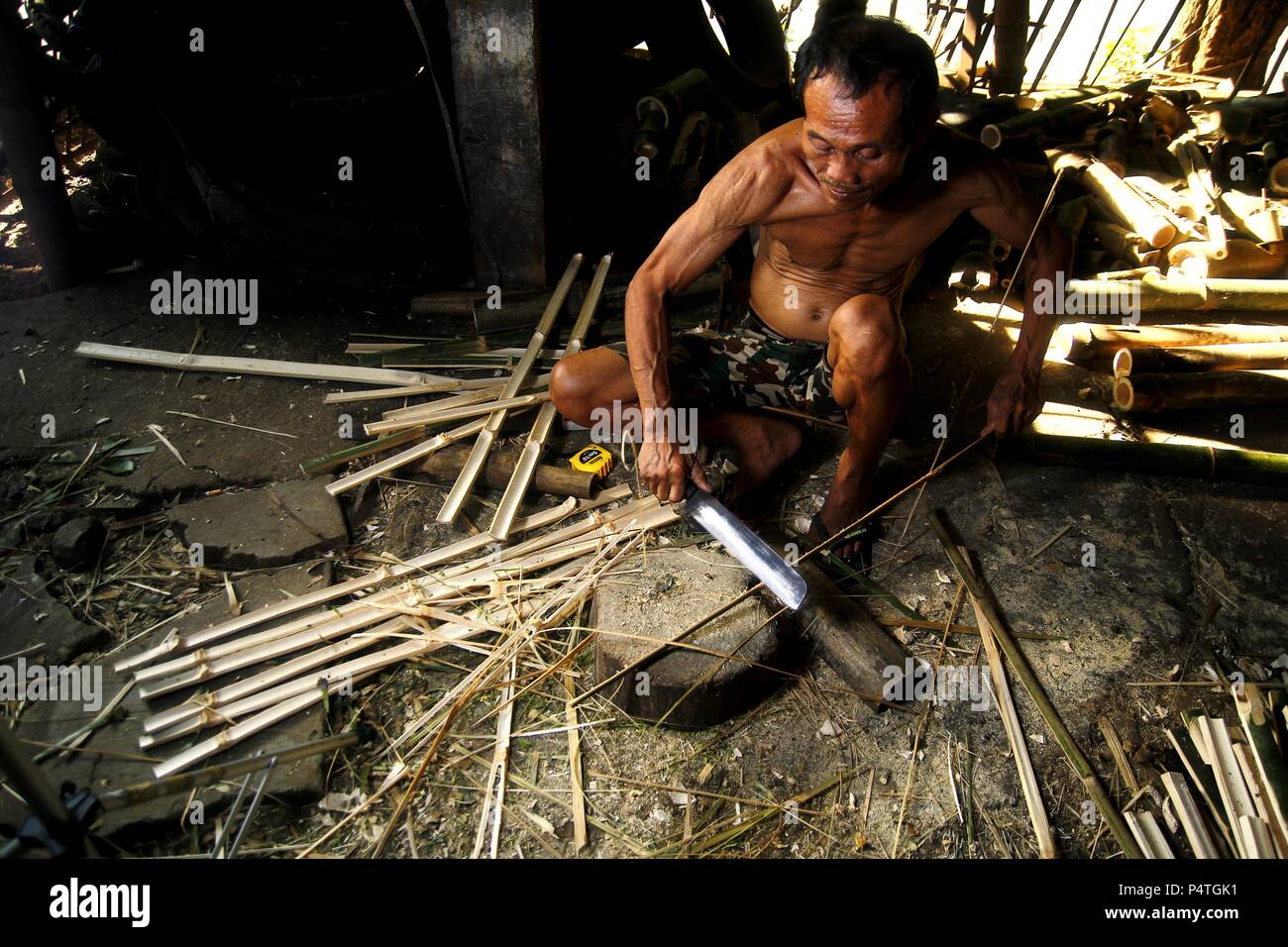 Photo of a bamboo furniture maker cutting bamboo Stock Photo Alamy