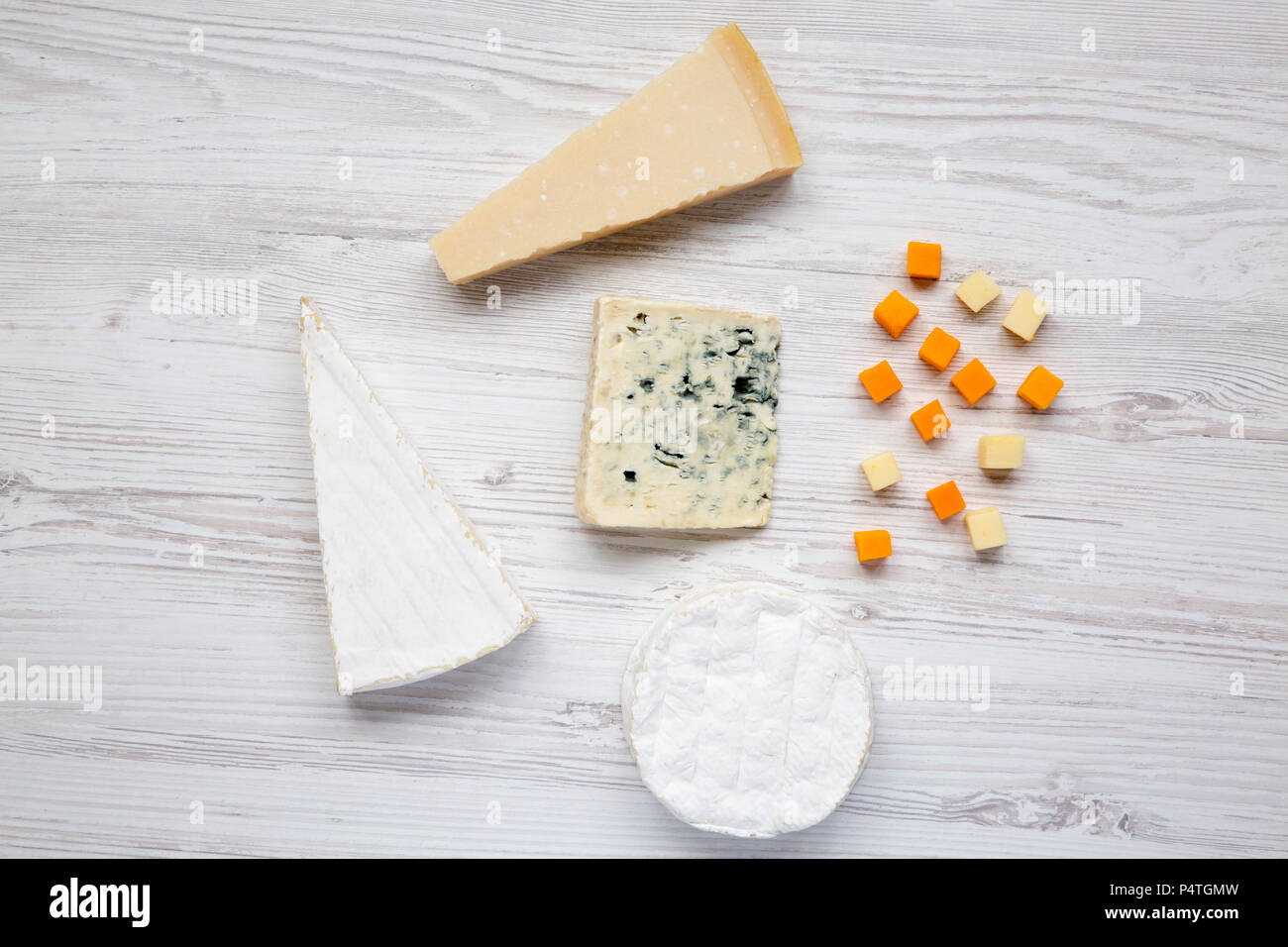 Different kinds of cheeses on white wooden table Stock Photo