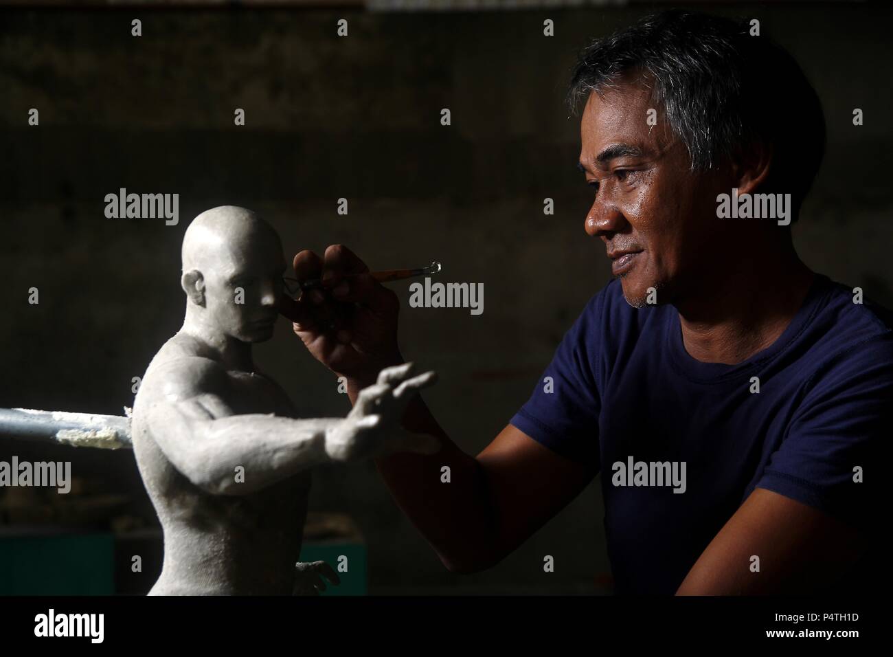 Photo of a sculptor working on a statue Stock Photo