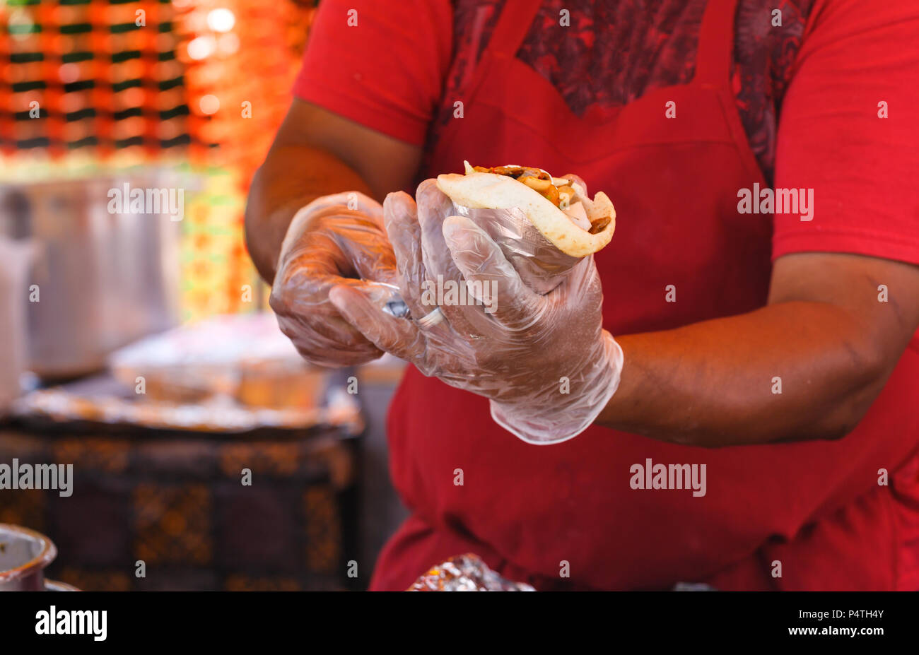 Man serving a gyro at an outdoor food event Stock Photo