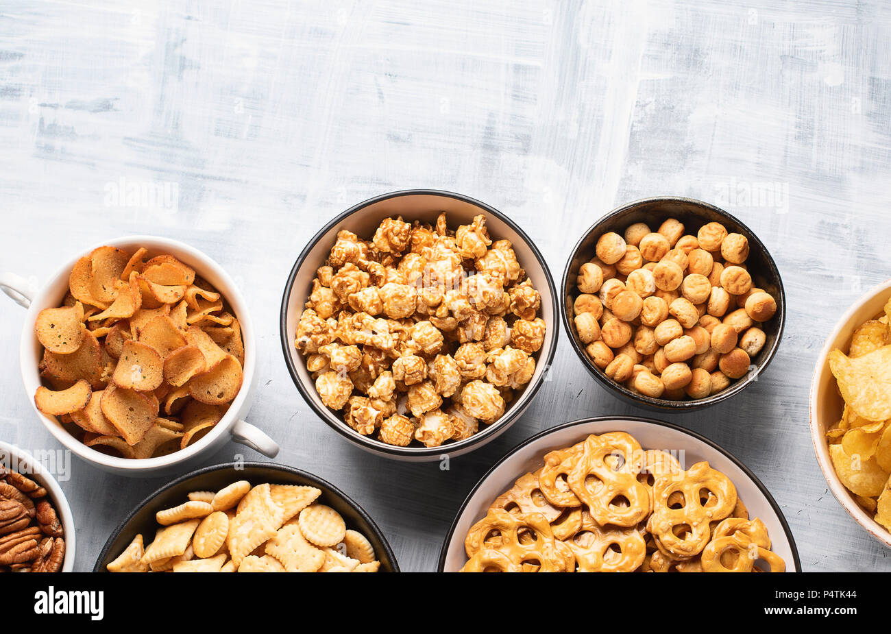 Different kids of snacks, chips, nuts and popcorn Stock Photo Alamy