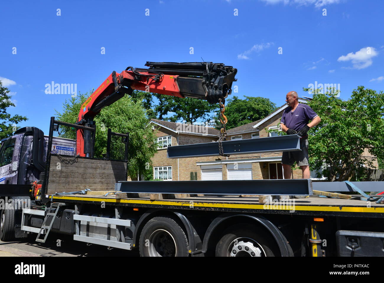 A crane lifting steel for an extension on a house in the UK Stock Photo