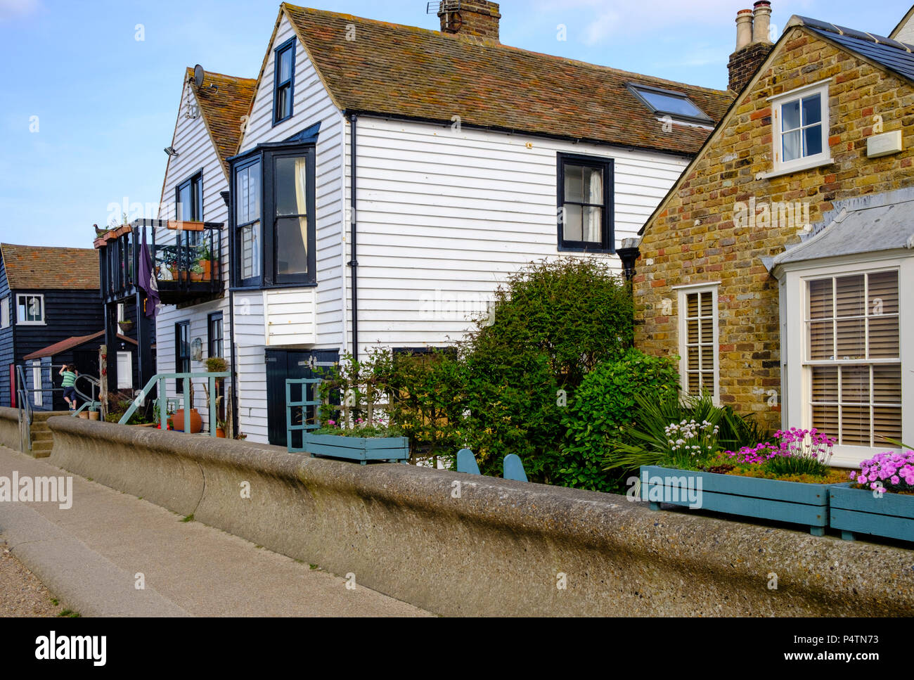 Timber clad seafront properties at Whitstable showing the protective