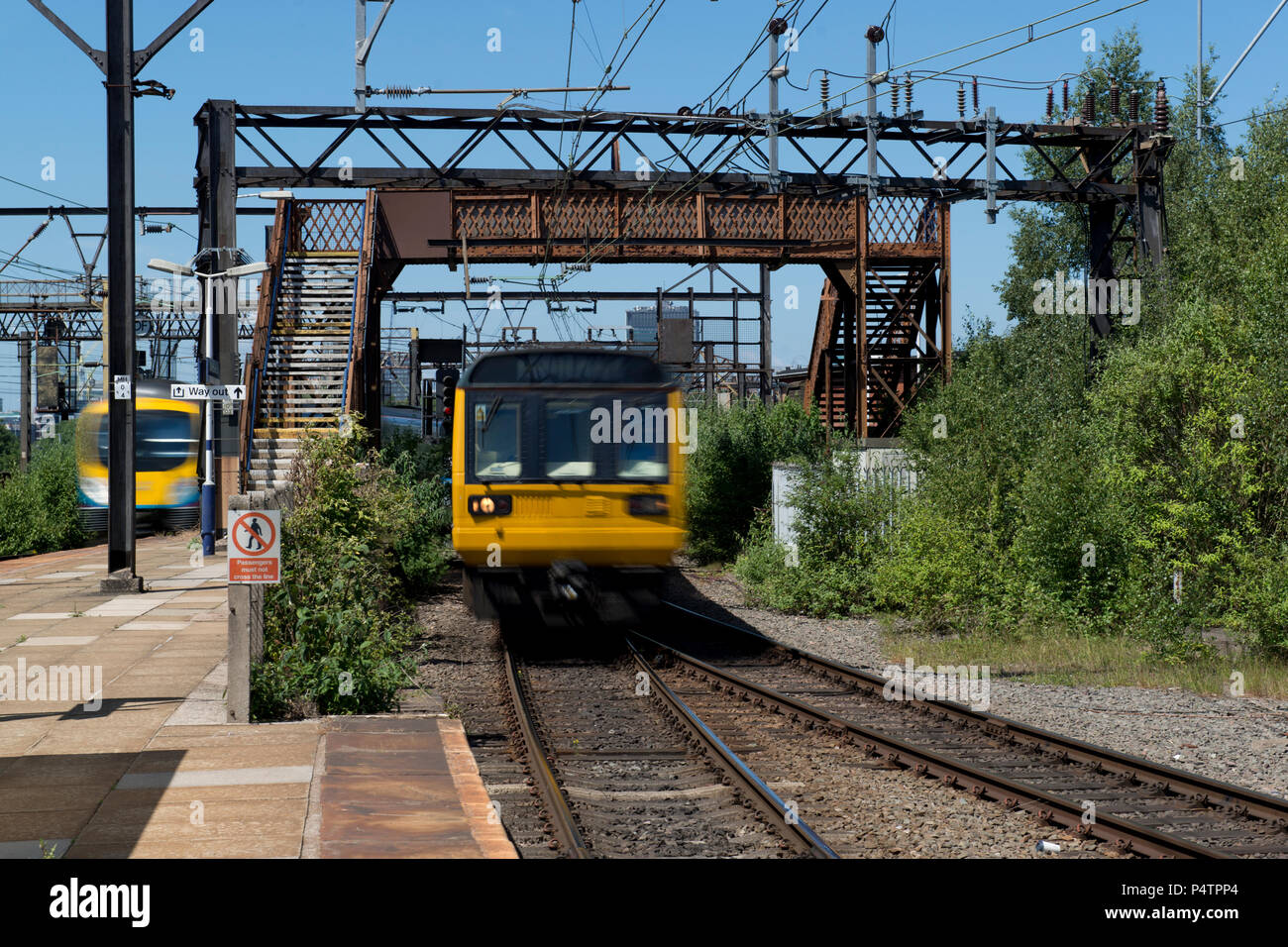 A British Rail Class 142 Pacer train passes through the run-down Ardwick railway station in Manchester. Stock Photo