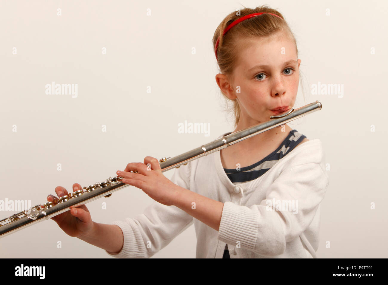 Young girl playing the flute. 