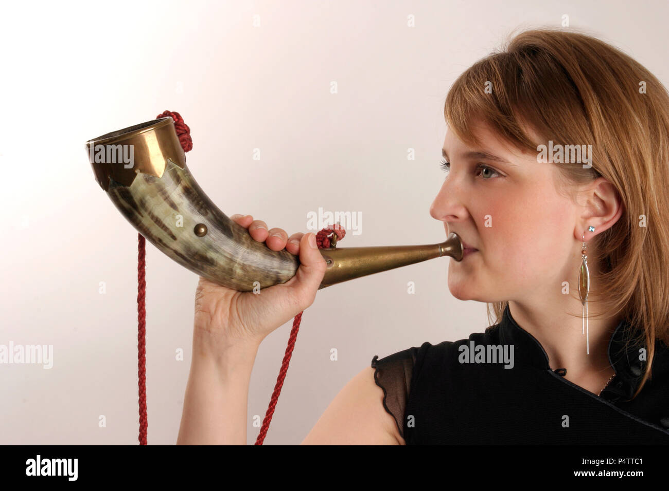 Cowhorn or natural animal horn with a mouthpiece being held in