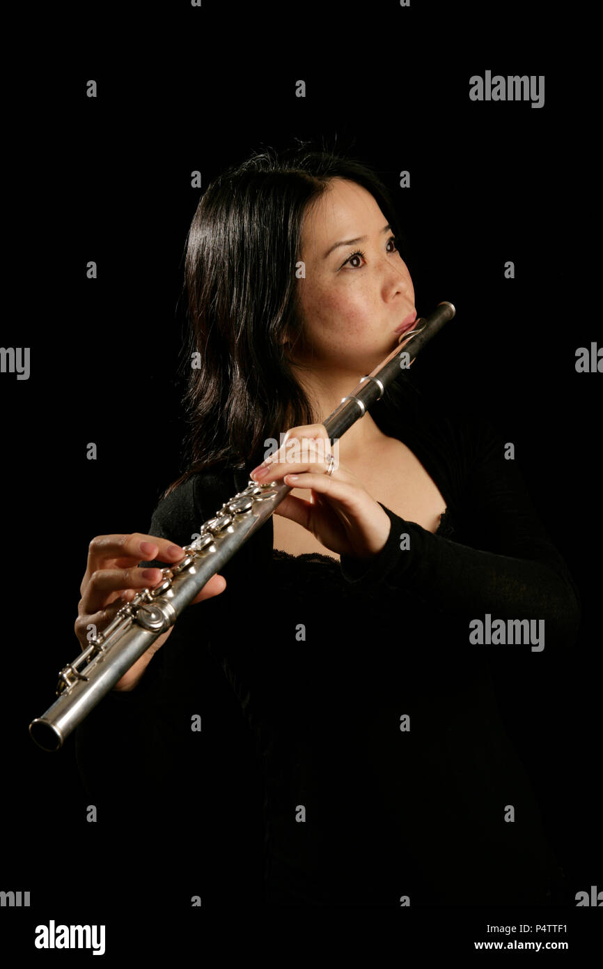 Young woman playing the flute Stock Photo Alamy