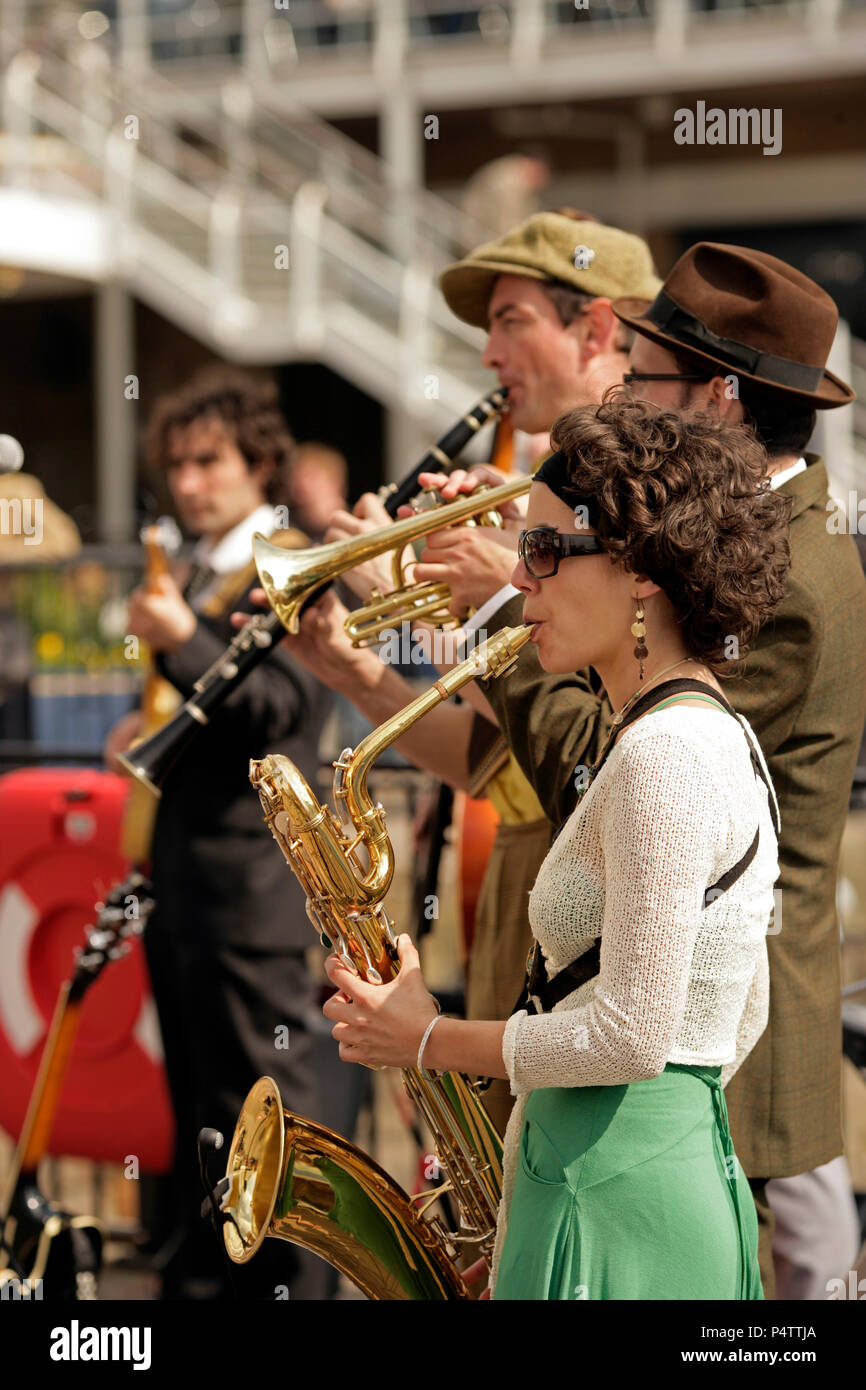 Jazz band performing in the open air. Baritone sax, cornet clarinet, guitar. Cardiff Bay. Stock Photo