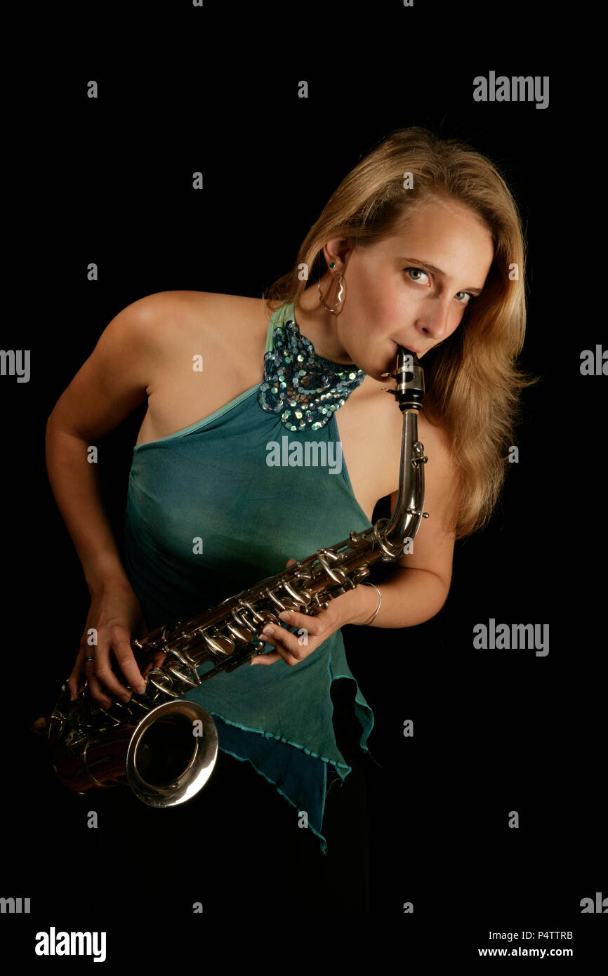 young white woman playing a silver alto sax Stock Photo