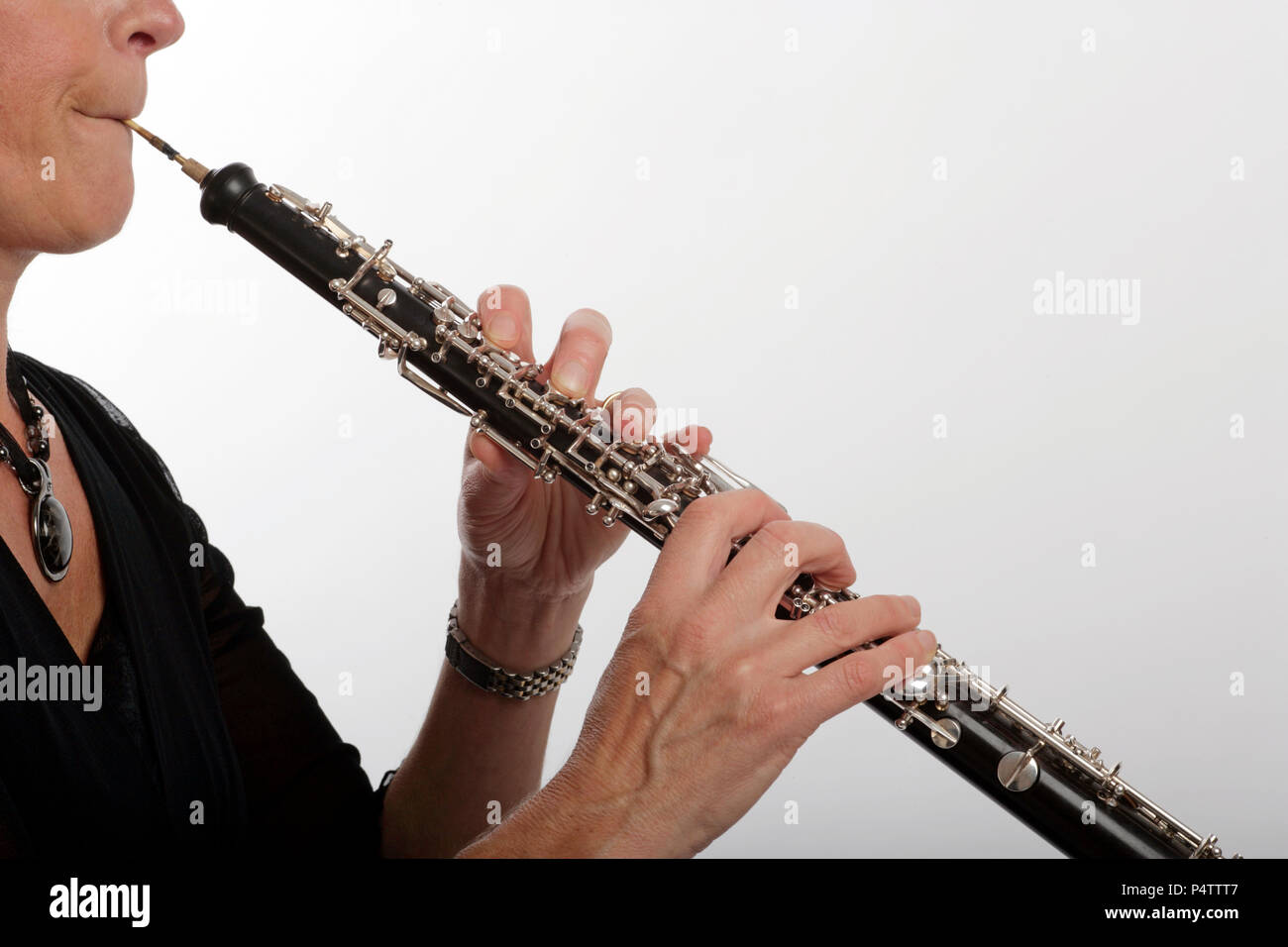 Oboe closeup of fingers, keywork, keys, reed, embouchure Stock Photo
