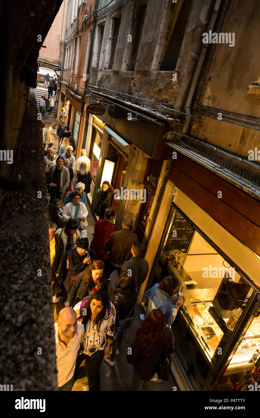 Tourists and shop windows in ancient Rialto alley in the oldest part of Venice,  Italy Stock Photo