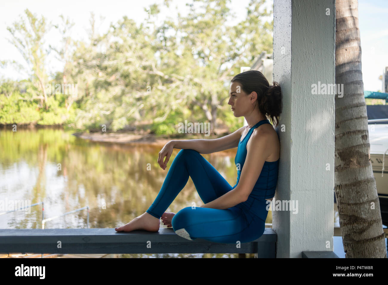 woman sitting in the shade resting after exercise Stock Photo