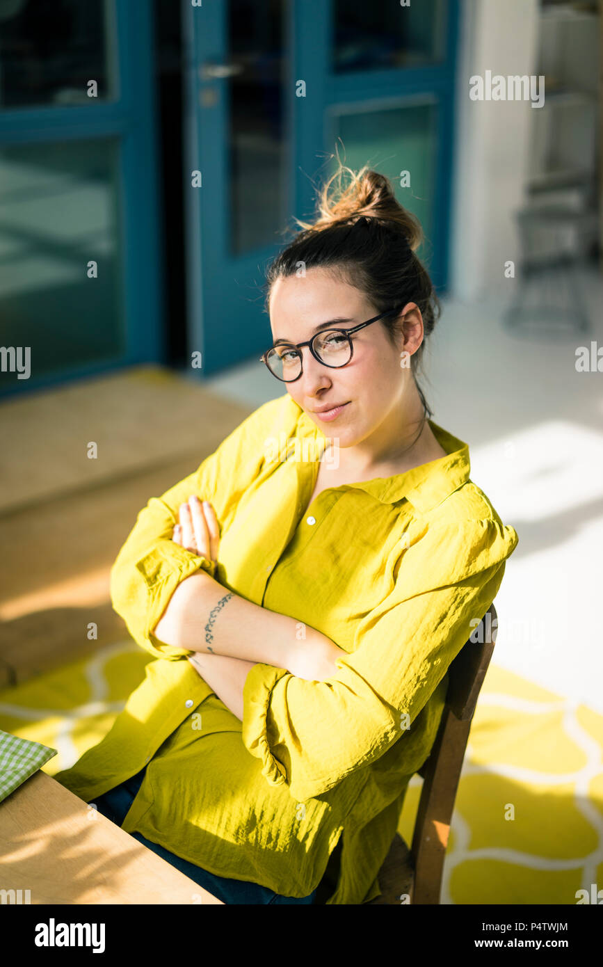 Portrait of young freelancer sitting at desk in her studio Stock Photo