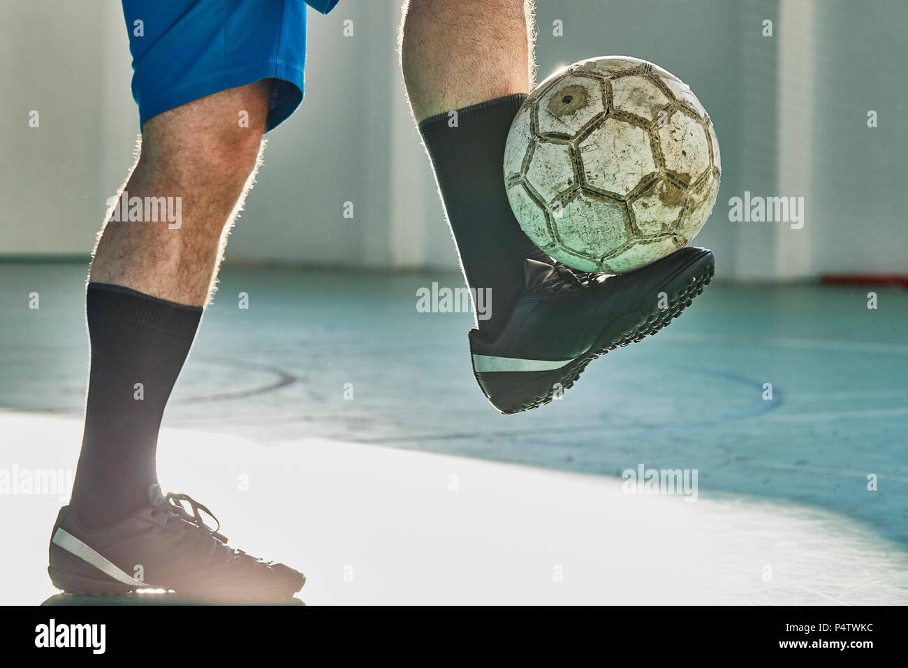 Indoor soccer player balancing the ball Stock Photo