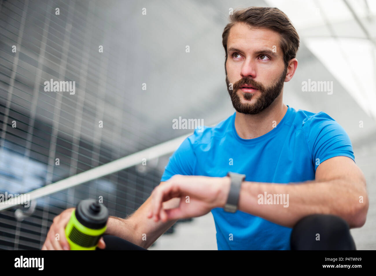 Man sitting on stairs having a break from running Stock Photo
