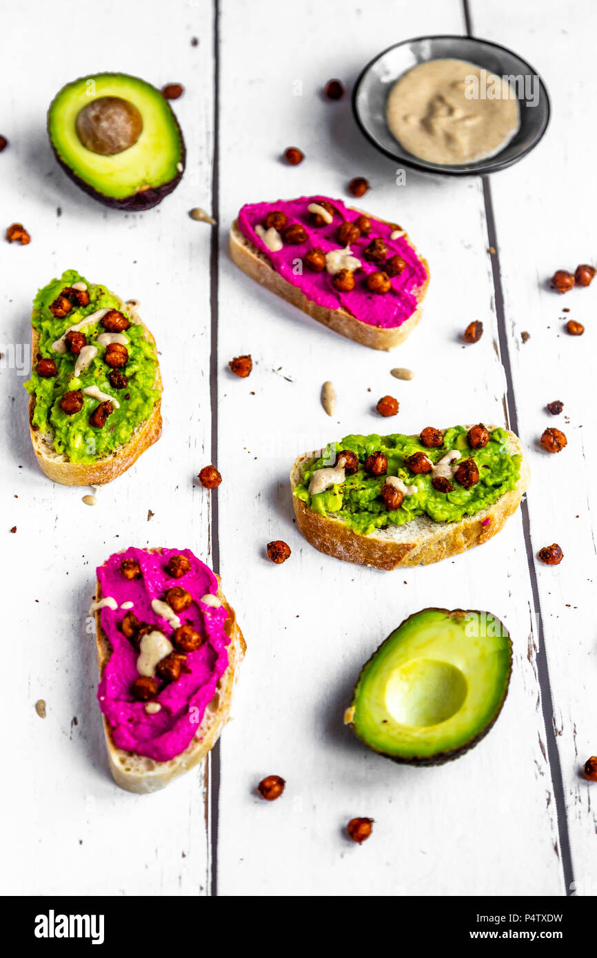 Baguette with guacomole and beetroot hummus, roasted chick peas and tahin dressing Stock Photo