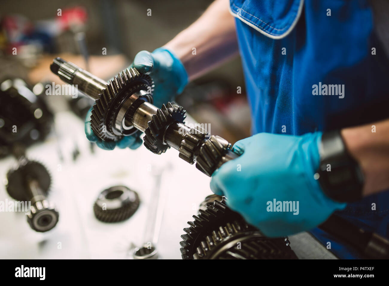 Close-up of mechanic working on the parts of a car in a workshop Stock Photo