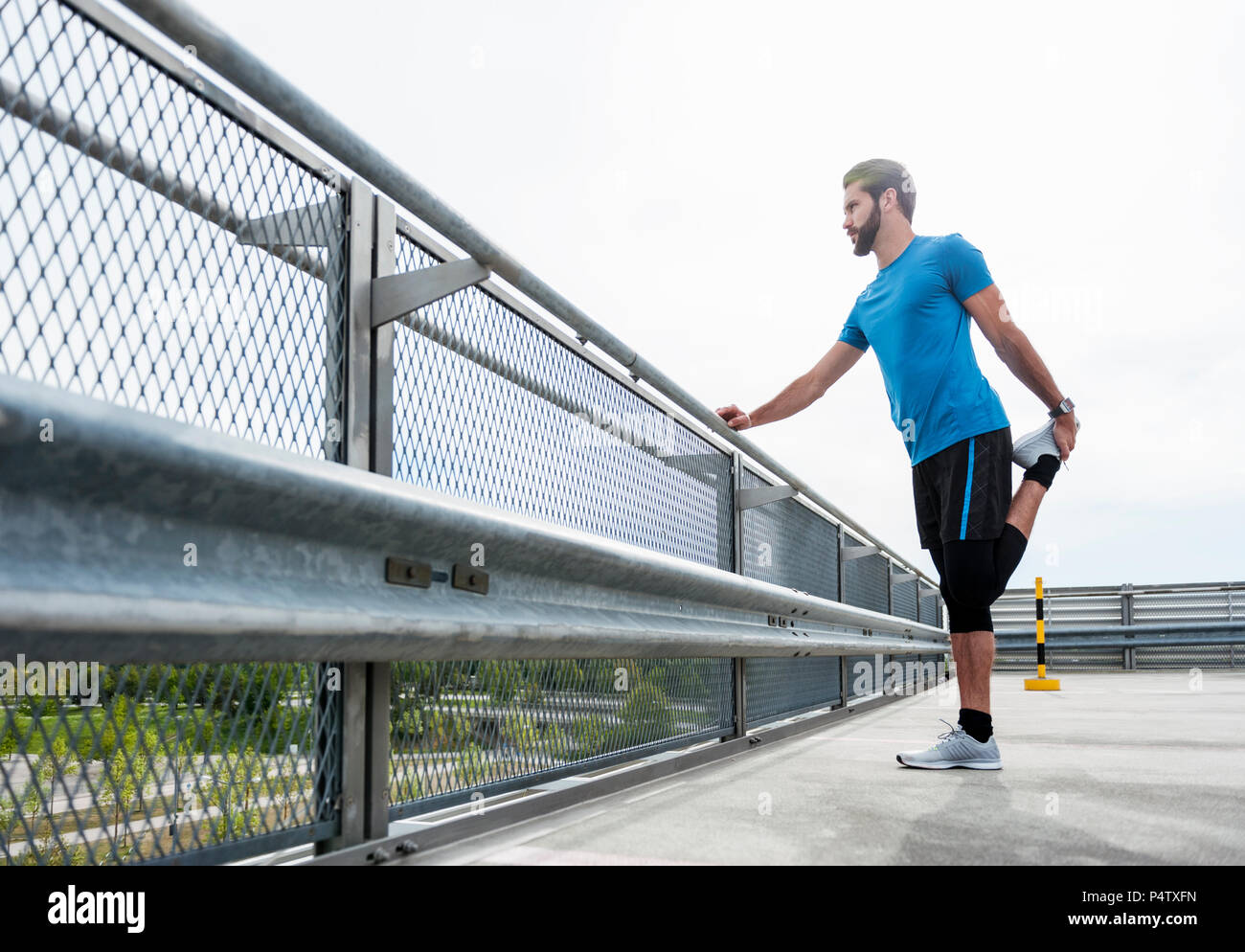 Man stetching on a parking level Stock Photo