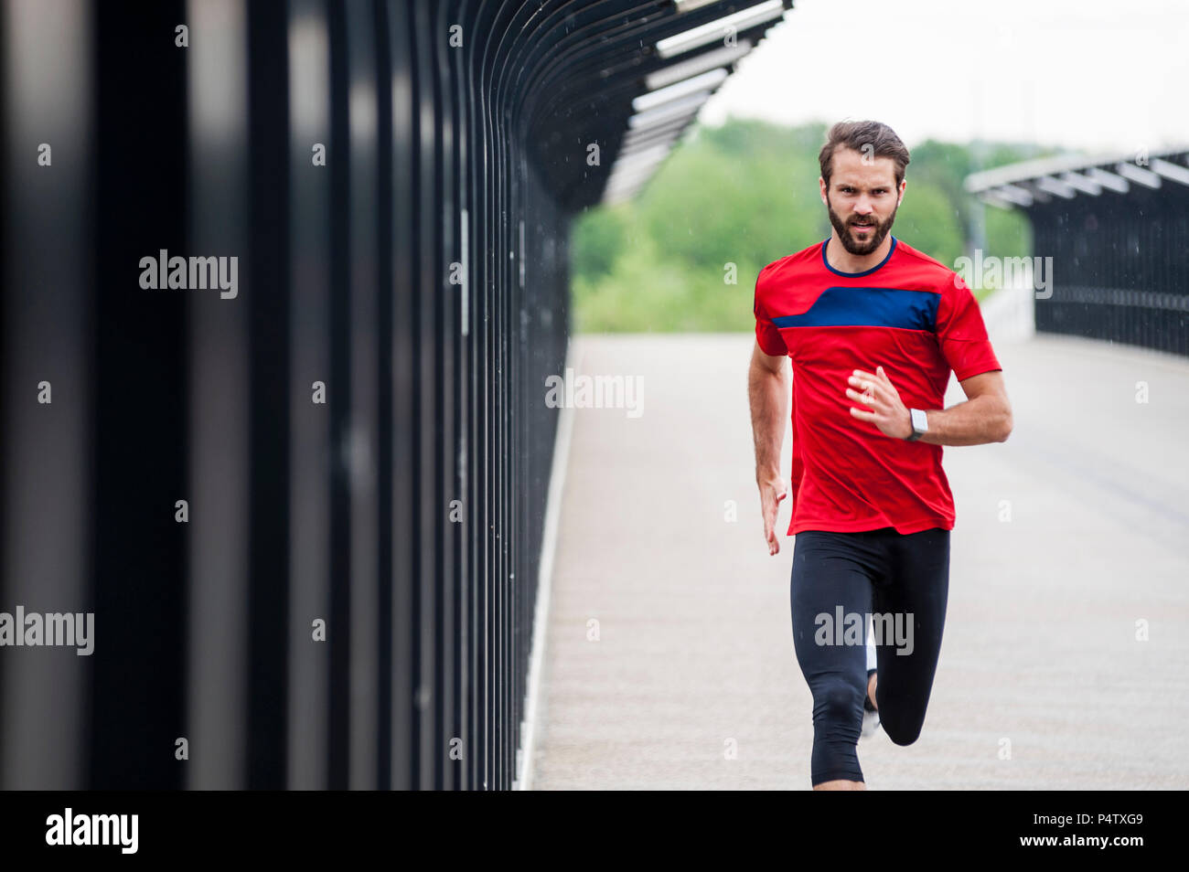 Man running on a bridge Stock Photo