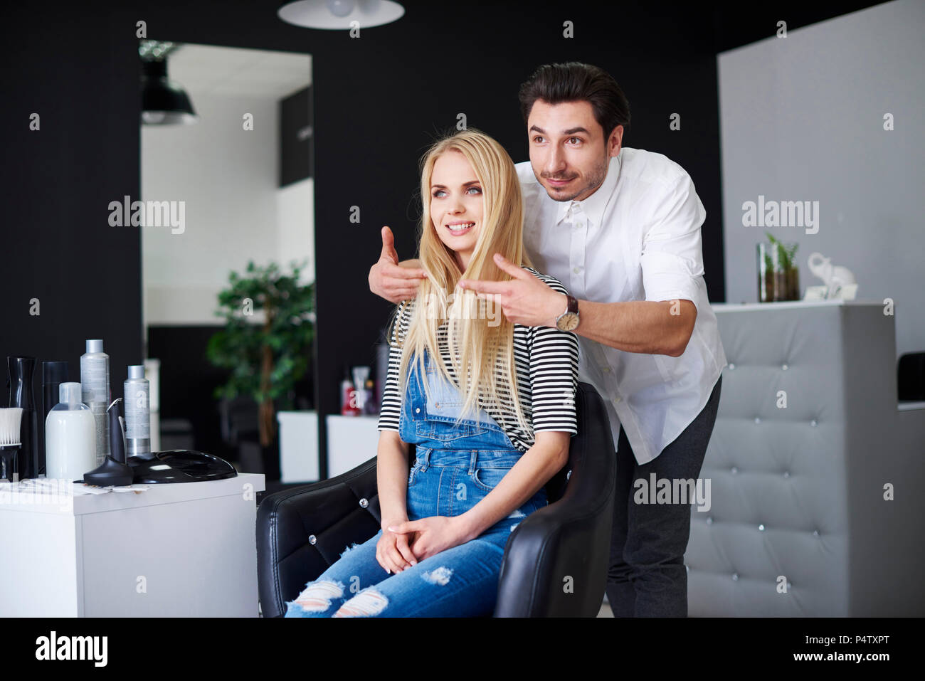 Hairdresser advising his customer Stock Photo