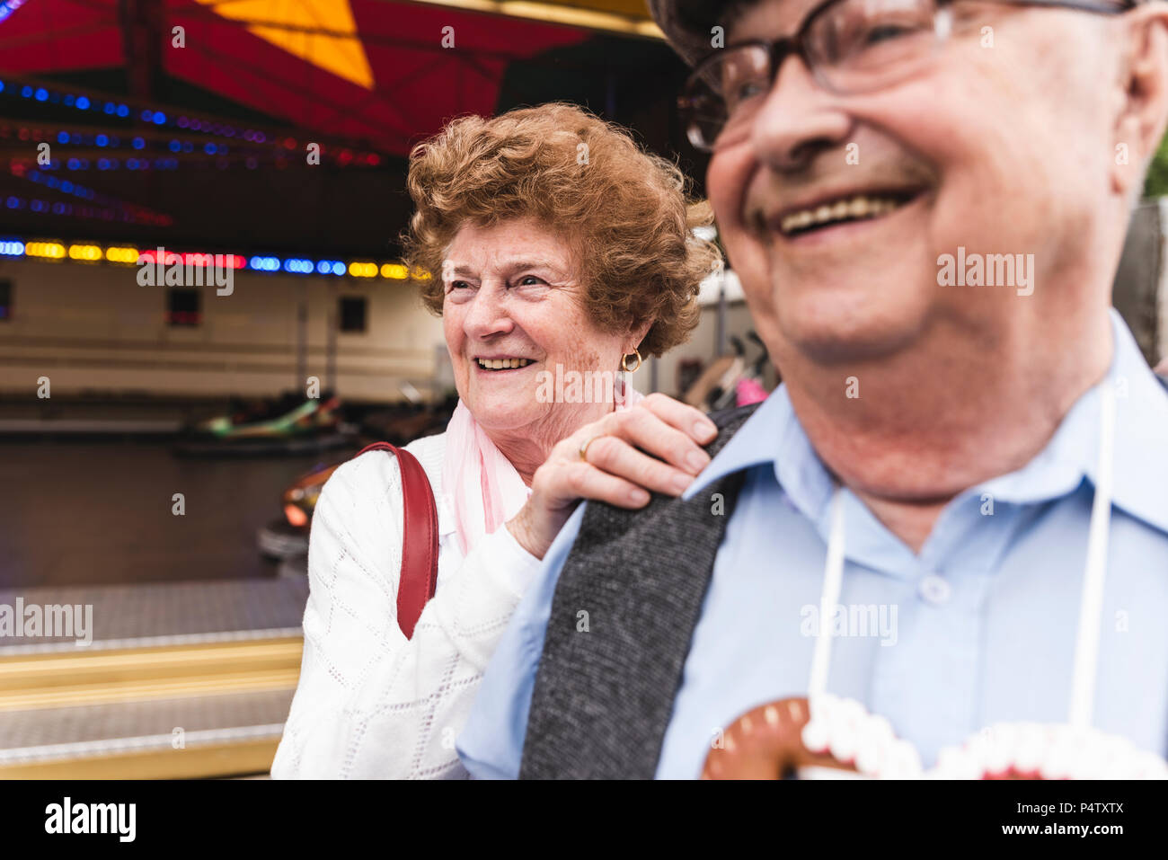 Portrait of senior woman having fun together with her husband on fair Stock Photo
