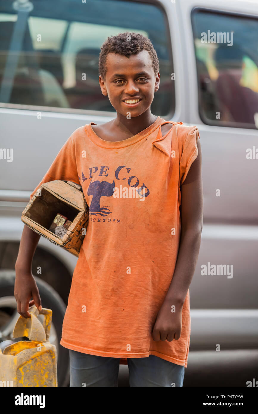 Addis Ababa, Ethiopia, January 27, 2014, Young teenager working as a shoe shine boy on the street, looking straight at the camera Stock Photo