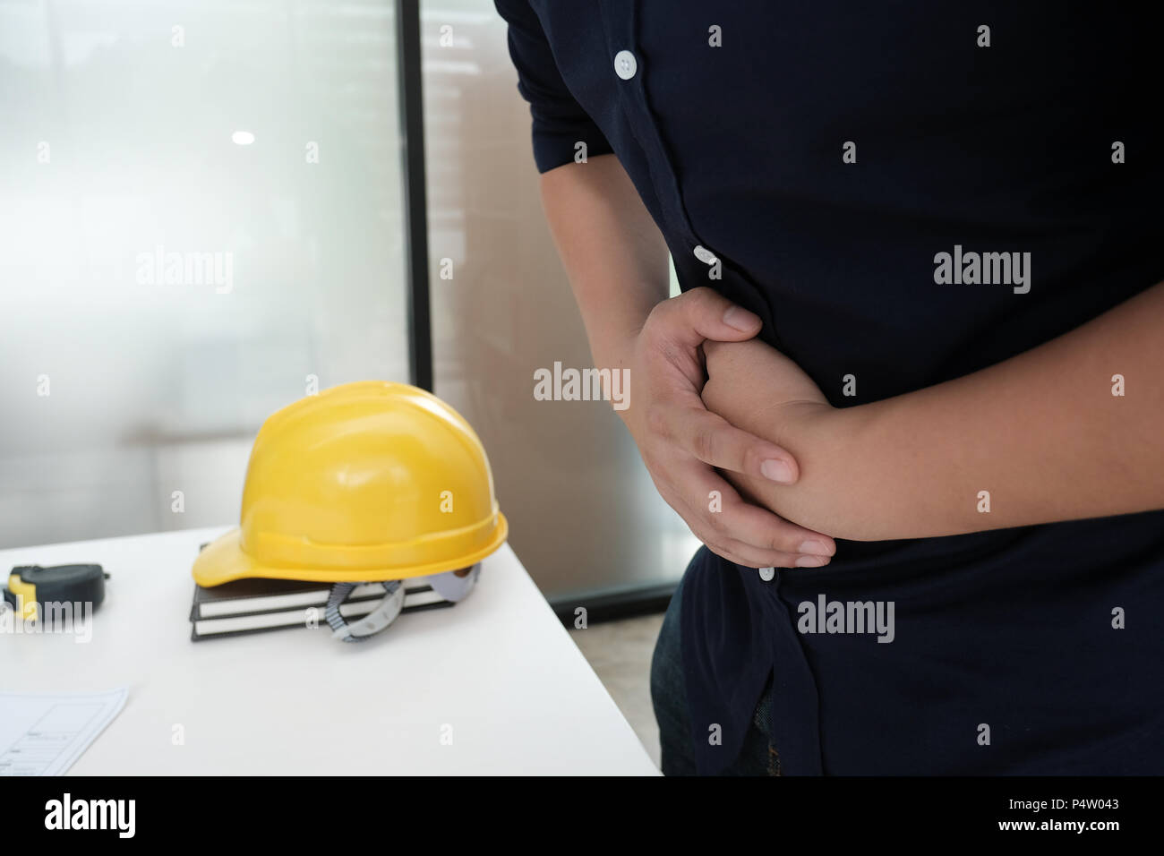engineer suffering from stomach ulcer, stomachache. man with diarrhea, food poisoning & abdominal pain Stock Photo