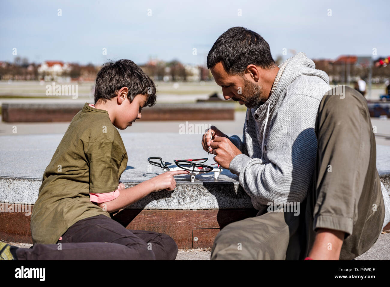 Father and son repairing drone Stock Photo - Alamy