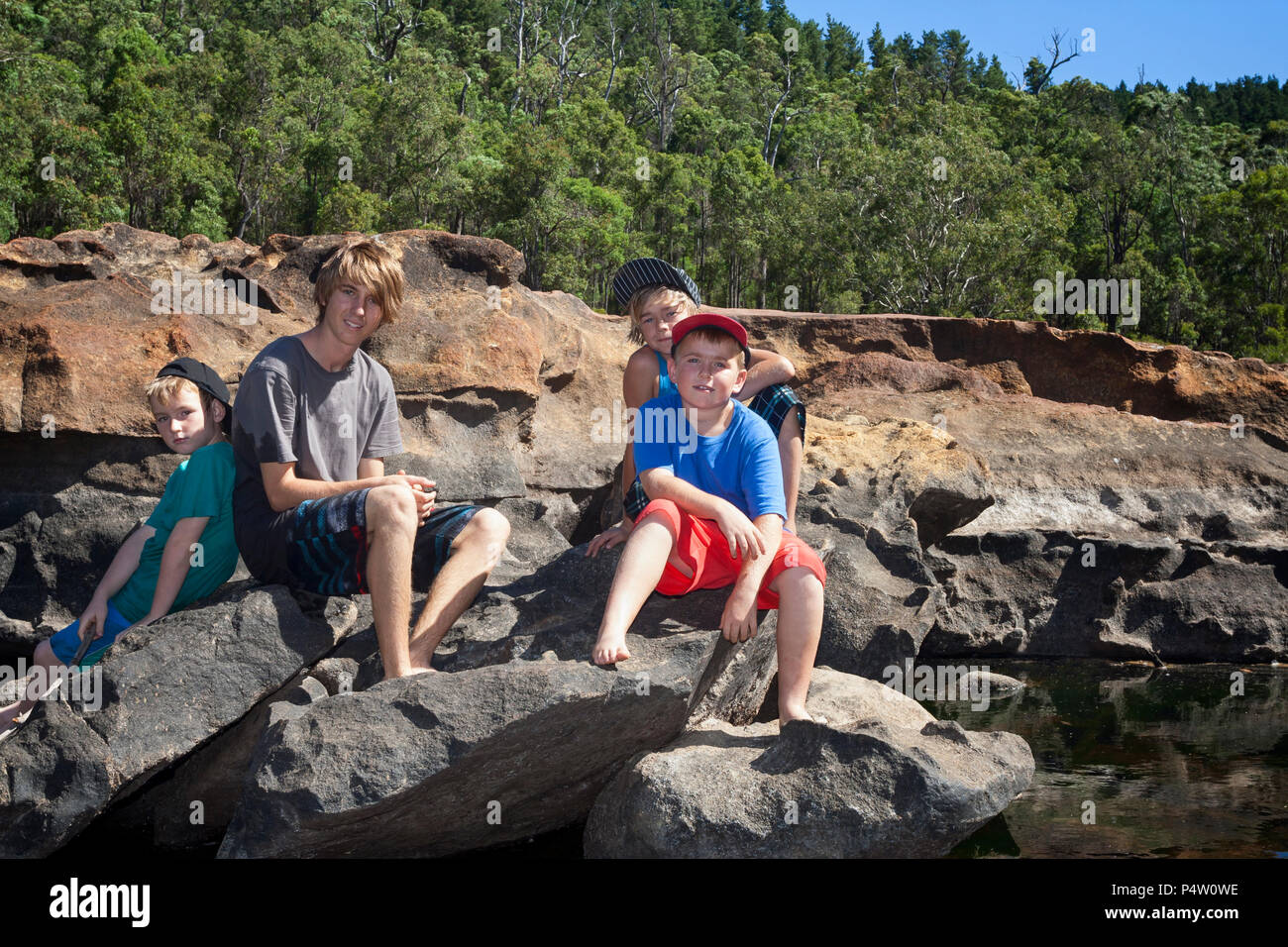 Boys Sitting On Rock River High Resolution Stock Photography and Images ...