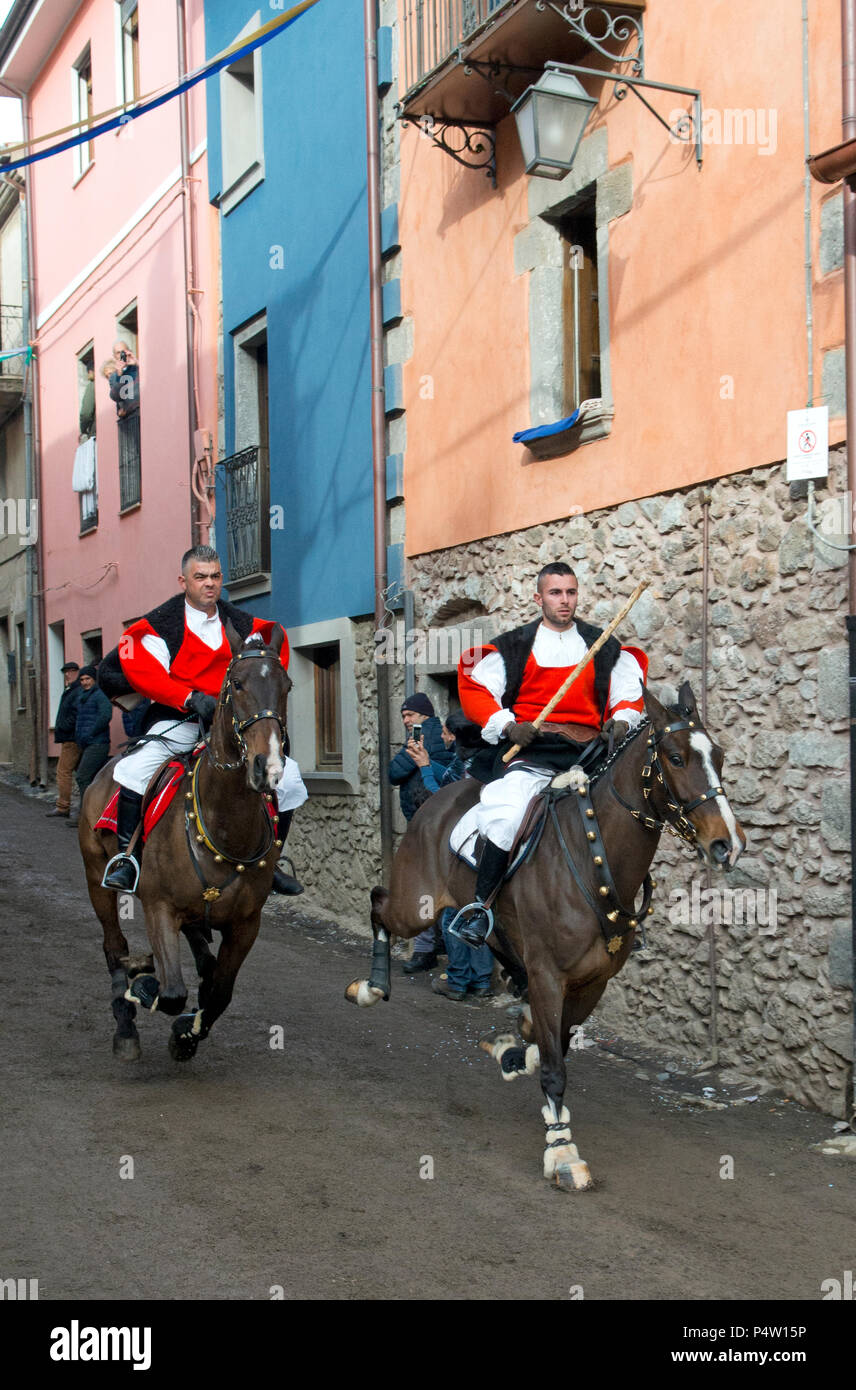 Couple ride reckless horserace 'Sa Carrela e Nanti', during the carnival at Santu Lussurgiu, Oristano, Sardinia, Italy, Europe Stock Photo