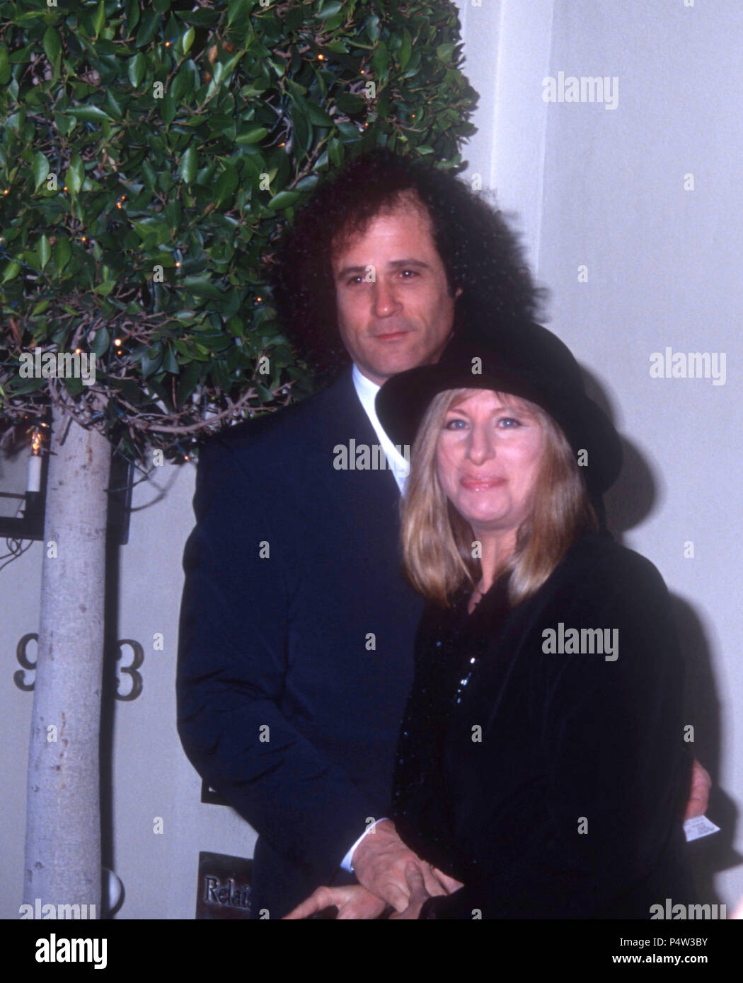 WEST HOLLYWOOD, CA - JANUARY 10: (L-R) Composer Richard Baskin and singer Barbra Streisand attend the Wedding Reception for Jane Fonda and Ted Turner on January 10, 1992 at L'Orangerie Restaurant in West Hollywood, California. Photo by Barry King/Alamy Stock Photo Stock Photo
