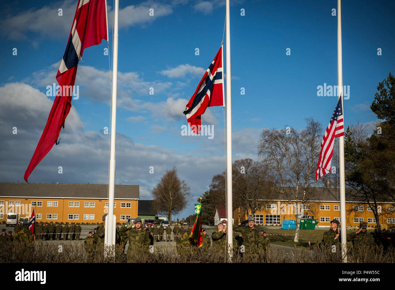 U.S. Marines and Norwegian soldiers raise the colors during a Victory in Europe Day ceremony in Stjørdal, Norway, May 8, 2017. Victory in Europe Day, known as VE Day, marks the day Nazi Germany surrendered to Allied Forces during World War II. Marine Rotational Force Europe 17.1 preserves the U.S.’s commitment to Norway and our mutual trust as we confront evolving strategic challenges together. Stock Photo