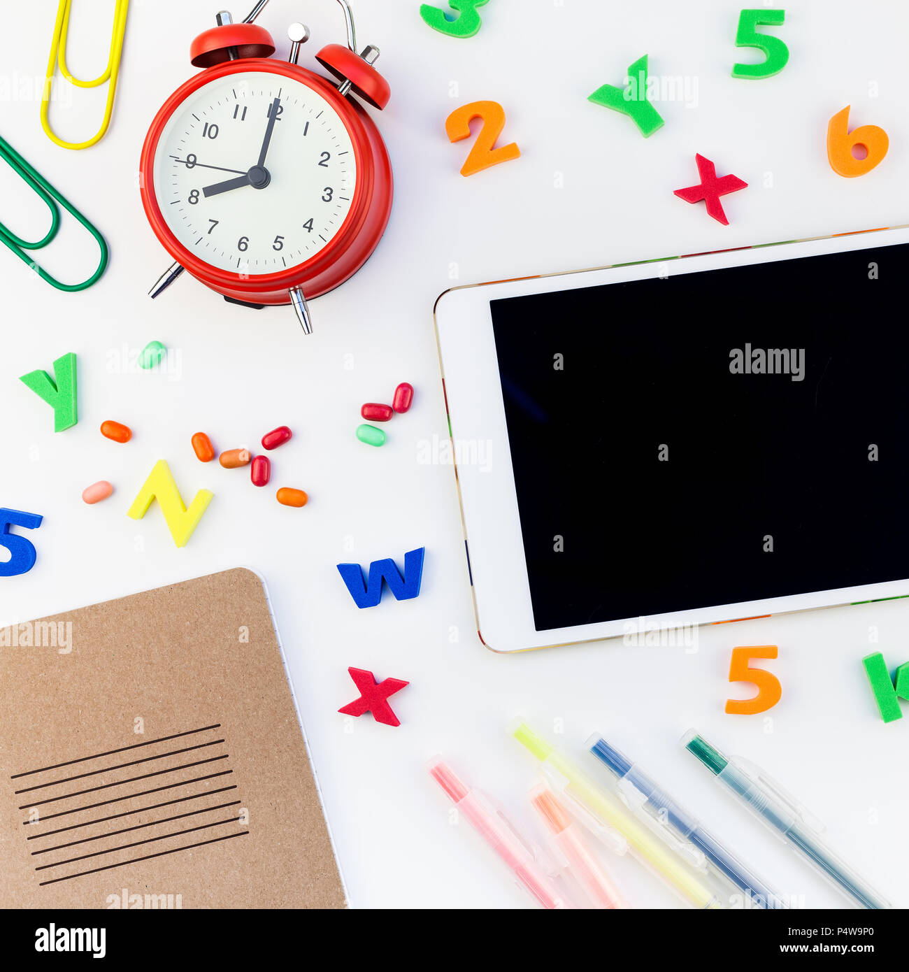 Square flat lay back to school concept blank tablet with alarm clock ...