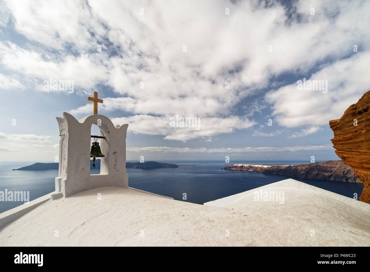 Wide view from the crater rim over the roof of a typical church to the opposite islands - Location: Greece, Cyclades, Santorini (Santorin, Thira) Stock Photo