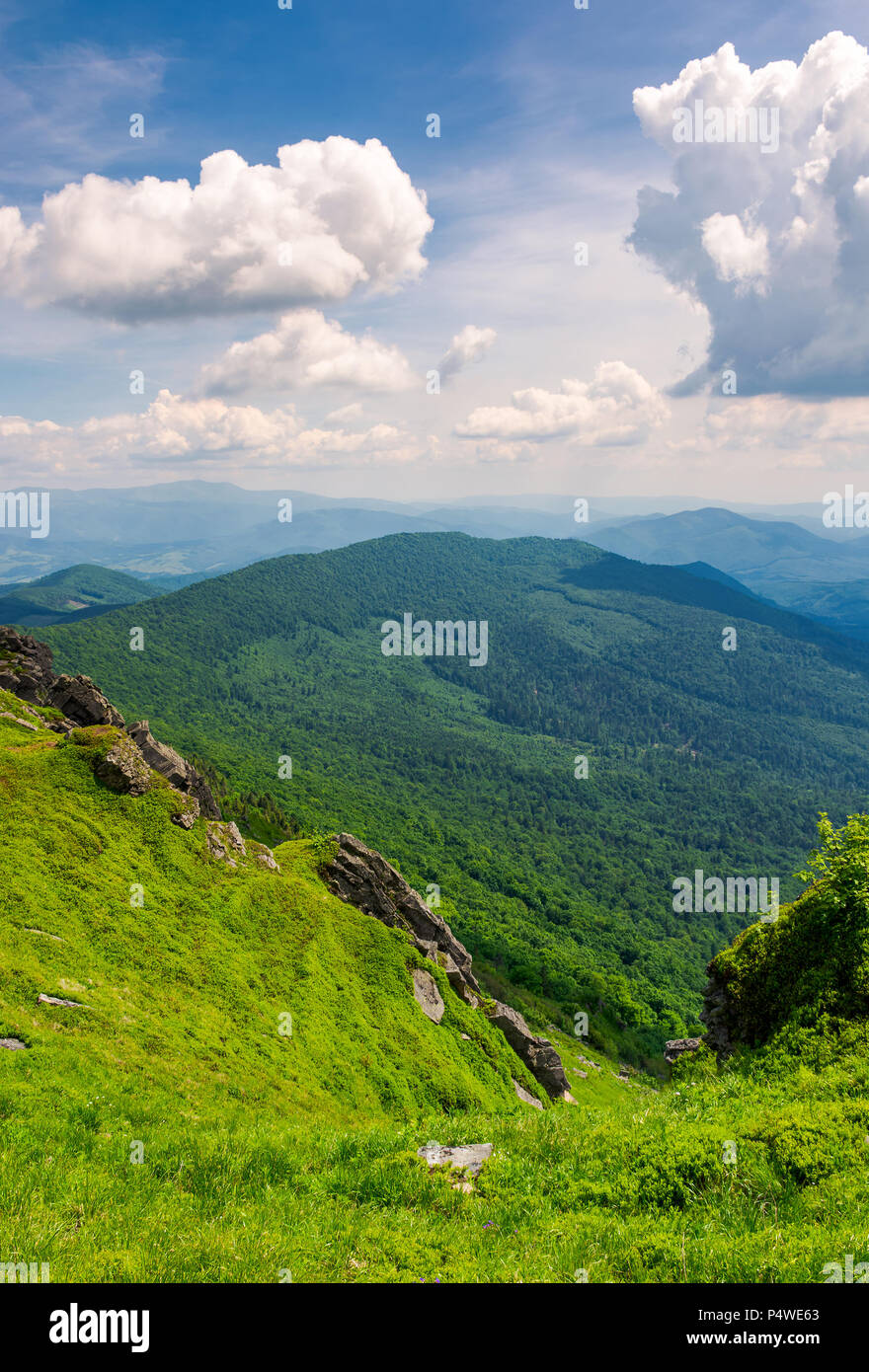 cliffs and grassy hills of Pikui mountain. beautiful view from the top. Borzhava ridge in the distance. lovely summer scenery with beautiful cloudscap Stock Photo